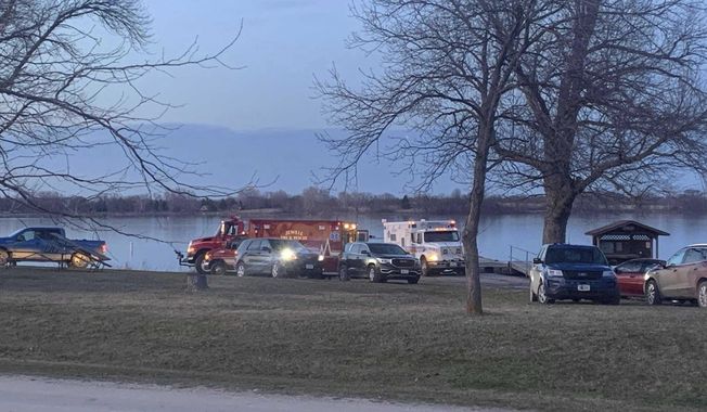 Responders and search crews gather at Little Wall Lake Sunday evening, March 28, 2021, after five members of the Iowa State Crew Club were involved in a boating accident earlier in the morning. (Amber Mohmand/The Des Moines Register via AP)
