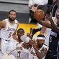 Orlando Magic center Mo Bamba (5) grabs a rebound over Los Angeles Lakers guard Kentavious Caldwell-Pope (1) and Dennis Schroder (17) during the first half of an NBA basketball game Sunday, March 28, 2021, in Los Angeles. (AP Photo/Marcio Jose Sanchez)