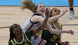 UConn guard Paige Bueckers, center, drives to the basket between Baylor defenders Queen Egbo (25) and DiJonai Carrington (21) during the first half of a college basketball game in the Elite Eight round of the women&#39;s NCAA tournament at the Alamodome in San Antonio, Monday, March 29, 2021. (AP Photo/Eric Gay)