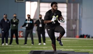 North Carolina running back Javonte Williams participates in the school&#39;s Pro Day football workout for NFL scouts in Chapel Hill, N.C., Monday, March 29, 2021. (AP Photo/Gerry Broome)