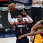 Washington Wizards guard Russell Westbrook (4) shoots past Indiana Pacers center Myles Turner (33) and guard Malcolm Brogdon, back right, during the first half of an NBA basketball game Monday, March 29, 2021, in Washington. (AP Photo/Alex Brandon)