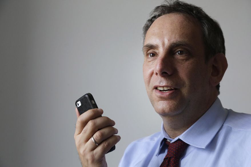 FILE - In this Wednesday, March 25, 2015 file photo, StoryCorps founder Dave Isay holds a smartphone in the Brooklyn borough of New York. One Small Step, which Isay established in 2018, is among a growing number of nonprofit initiatives whose aim is to narrow America's increasingly toxic political divide. (AP Photo/Mark Lennihan)