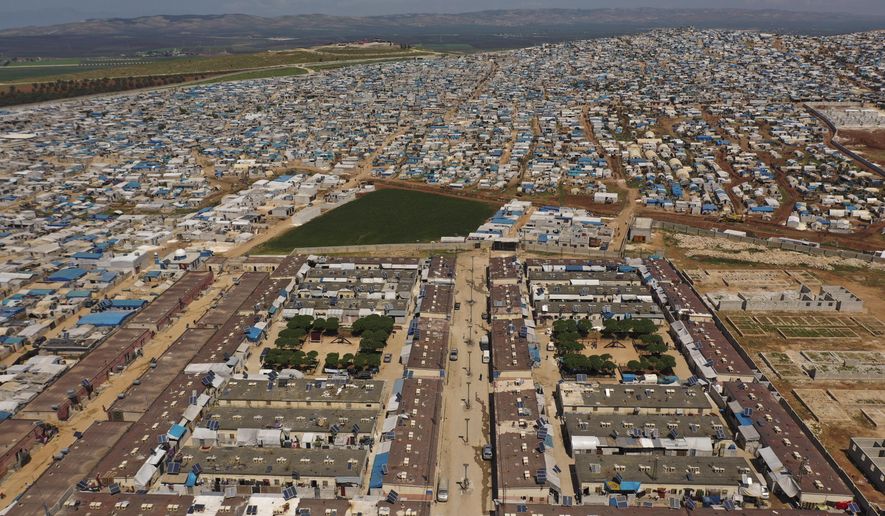 FILE - In this April 19, 2020 file photo, shows a large refugee camp on the Syrian side of the border with Turkey, near the town of Atma, in Idlib province, Syria. The humanitarian situation across war-ravaged Syria is worsening. But it’s been getting tougher every year to raise money from global donors to help people affected by the country’s protracted humanitarian crisis. The aid community is bracing for significant shortfalls ahead of a donor conference that starts Monday, March 29, 2021, in Brussels. (AP Photo/Ghaith Alsayed, File)