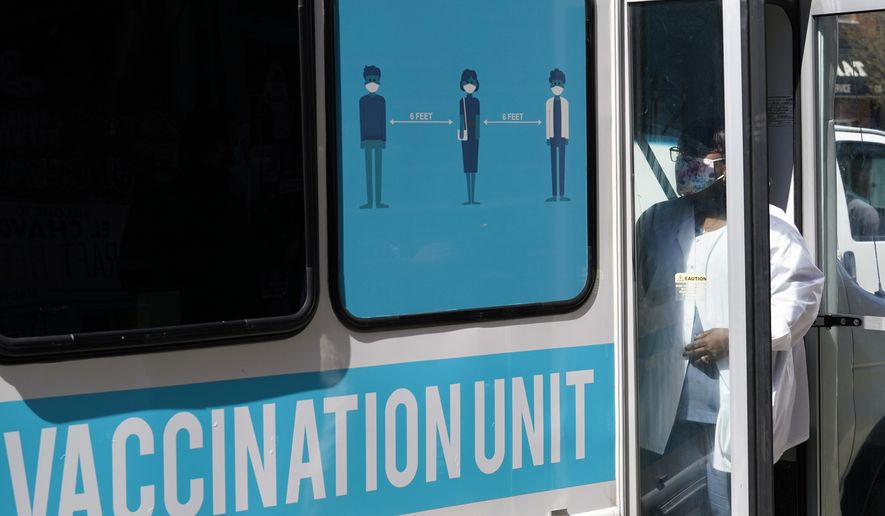 A health care worker stands at the door of a mobile vaccination van parked on a street corner in the Sunset Park neighborhood of Brooklyn, Monday, March 29, 2021, in New York. As part of New York City&#x27;s ongoing efforts to increase access to the COVID-19 vaccine citywide, NYC Test &amp;amp; Trace Corps added mobile vaccination to its community vaccine clinic program on Monday, launching this clinic-on-wheels with partner Mixteca, a community organization serving the Spanish-speaking and indigenous population in Brooklyn. (AP Photo/Kathy Willens) **FILE**