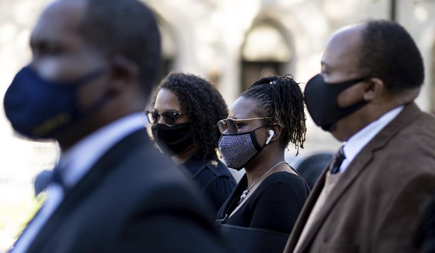 Georgia State Rep. Park Cannon, D-Atlanta,, center, walks beside Martin Luther King, III, as she returns to the State Capitol in Atlanta on Monday morning, March 29, 2021 after being arrested last week for knocking on the governor's office door as he signed voting legislation. (AP Photo/Ben Gray)