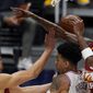 Philadelphia 76ers forward Danny Green, center, fights for control of a rebound with Denver Nuggets forwards Michael Porter Jr., left, and Will Barton in the first half of an NBA basketball game Tuesday, March 30, 2021, in Denver. (AP Photo/David Zalubowski)
