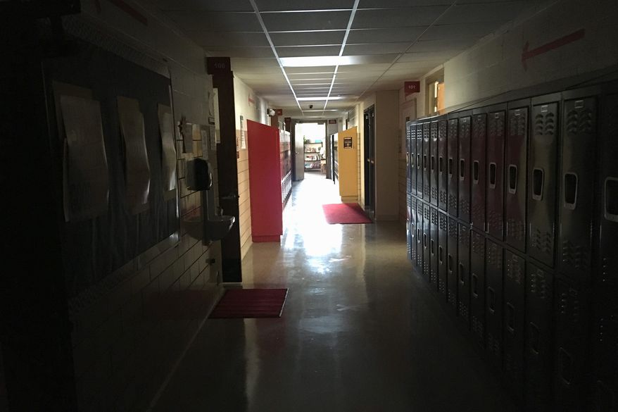 In this file photo, an empty hallway is shown at a school in Detroit, Mich., Monday, Feb. 8, 2021.  Associated Press) ** FILE **