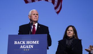 In this Jan. 20, 2021, photo, former Vice President Mike Pence speaks after arriving back in his hometown of Columbus, Ind., as his wife Karen watches. Pence is steadily reentering public life as he eyes a potential run for the White House in 2024. He&#39;s writing op-eds, delivering speeches, preparing trips to early voting states and launching an advocacy group likely to focus on promoting the accomplishments of the Trump administration. (AP Photo/Michael Conroy) **FILE**