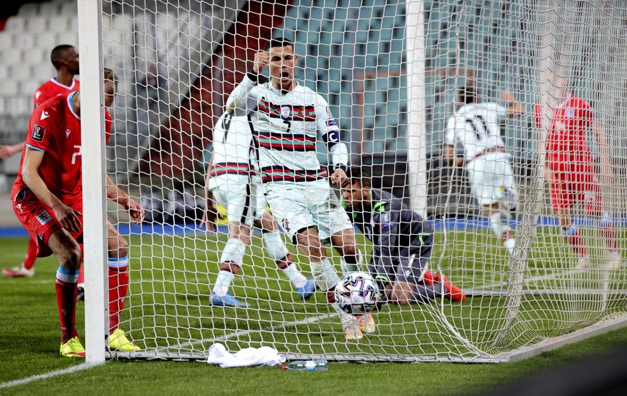 Portugal&#39;s Cristiano Ronaldo, center, jubilates as he follows the ball into the net after teammate Portugal&#39;s Joao Palhinha, second right, scored his sides third goal during the World Cup 2022 group A qualifying soccer match between Luxembourg and Portugal at the Josy Barthel Stadium in Luxembourg, Tuesday, March 30, 2021. (AP Photo/Olivier Matthys)