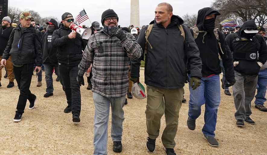 In this Jan. 6, 2021, photo, Proud Boys including Joseph Biggs, front left, walks toward the U.S. Capitol in Washington, in support of President Donald Trump. With the megaphone is Ethan Nordean, second from left. The Proud Boys and Oath Keepers make up a fraction of the more than 300 Trump supporters charged so far in the siege that led to Trump&#39;s second impeachment and resulted in the deaths of five people, including a police officer. But several of their leaders, members and associates have become the central targets of the Justice Department’s sprawling investigation. (AP Photo/Carolyn Kaster) **FILE**