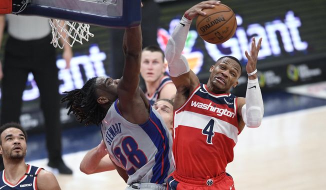 Washington Wizards guard Russell Westbrook (4) grabs the ball next to Detroit Pistons center Isaiah Stewart (28) during the second half of an NBA basketball game Saturday, March 27, 2021, in Washington. (AP Photo/Nick Wass)