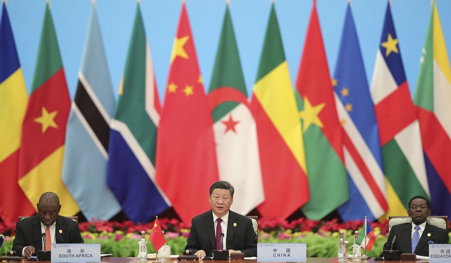 FILE - In this Sept. 4, 2018, file photo, Chinese President Xi Jinping speaks with South African President Cyril Ramaphosa, left, during the 2018 Beijing Summit of the Forum on China-Africa Cooperation - Round Table Conference at the Great Hall of the People in Beijing. China's loans to poor countries in Africa and Asia impose unusual secrecy and repayment terms that are hurting their ability to renegotiate debts after the coronavirus pandemic, a group of U.S. and German researchers said in a report Wednesday, March 31, 2021. (Lintao Zhang/Pool photo via AP, File)