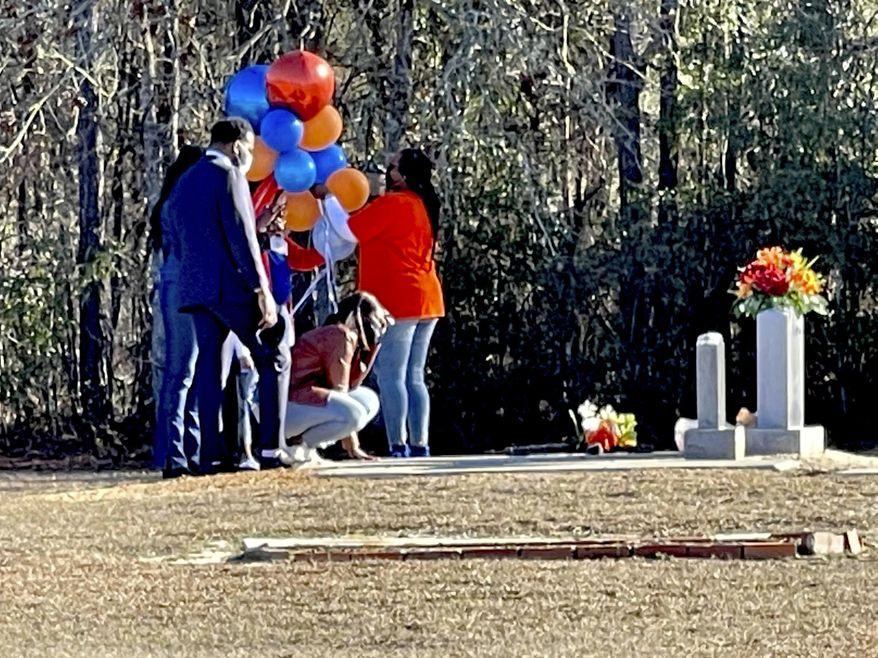 Wanda Cooper-Jones kneels before the grave of her son, Ahmaud Arbery, at the New Springfield Baptist Church in Waynesboro, Ga., on Tuesday, Feb. 23, 2021, to mark the one year anniversary of Ahmaud Arbery&#39;s death in Brunswick, Ga. Georgia lawmakers voted Wednesday, March 31, 2021, to repeal Georgia’s citizen’s-arrest law after the law was raised as a defense for the men accused of shooting Ahmaud Arbery near Brunswick, Georgia, in February 2020. (AP Photo/Lewis M. Levine, File)