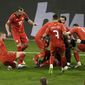 North Macedonia&#39;s Eljif Elmas, not seen in the frame, celebrates with his teammates after scoring his side&#39;s second goal during the World Cup 2022 group J qualifying soccer match between Germany and North Macedonia in Duisburg, Germany, Wednesday, March 31, 2021. (Thilo Schmuelgen/Pool via AP)