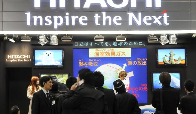 FILE - In this Dec. 11, 2008 file photo, visitors crowd at a booth of Japanese electronics maker Hitachi Ltd. at an ecology fair in Tokyo, Japan. Hitachi Ltd. Is buying U.S. digital engineering services company GlobalLogic Inc. for $9.6 billion, the Japanese industrial, electronic and construction conglomerate said Wednesday, March 31, 2021. (AP Photo/Katsumi Kasahara, File)