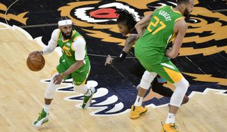 Utah Jazz guard Mike Conley (10) drives past Memphis Grizzlies guard Ja Morant with help from center Rudy Gobert (27) during the first half of an NBA basketball game Wednesday, March 31, 2021, in Memphis, Tenn. (AP Photo/Brandon Dill)