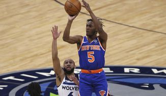 New York Knicks&#39; Immanuel Quickley (5) shoots over Minnesota Timberwolves&#39; Jordan McLaughlin (6) during the first half of an NBA basketball game Wednesday, March 31, 2021, in Minneapolis. (AP Photo/Stacy Bengs)