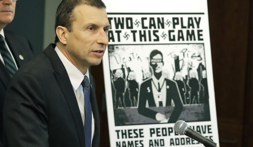 FILE - In this Feb. 26, 2020, file photo, Raymond Duda, FBI Special Agent in Charge in Seattle, speaks as he stands next to a poster that was mailed earlier in the year to the home of Chris Ingalls, an investigative reporter with KING-TV during a news conference in Seattle. A federal judge declined to impose prison time Wednesday, March 31, 2021, on a former member of a neo-Nazi ring that made threats against journalists, finding that the 21-year-old, who concealed his transgender identity from his co-conspirators, had already suffered enough in his young life. (AP Photo/Ted S. Warren, File)