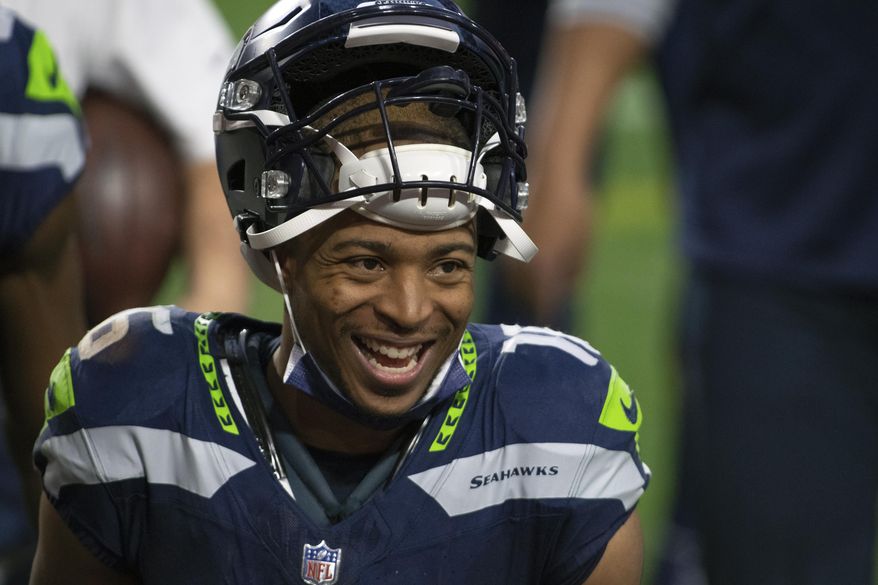 FILE - Seattle Seahawks wide receiver Tyler Lockett smiles after an NFL football game against the San Francisco 49ers in Glendale, Ariz., in this Sunday, Jan. 3, 2021, file photo. The Seattle Seahawks and veteran wide receiver Tyler Lockett have agreed to a four-year contract extension that includes $37 million guaranteed, according to a person with knowledge of the deal. The person spoke to The Associated Press on Wednesday, March 31, 2021, on the condition of anonymity because the extension had not been announced by the team. (AP Photo/Jennifer Stewart, File)