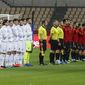 From left to right, Kosovo and Spain national team players listen national anthems prior their World Cup 2022 Group B qualifying round soccer match at La Cartuja stadium in Seville, Spain, Wednesday March 31, 2021. (AP Photo/Miguel Angel Morenatti)