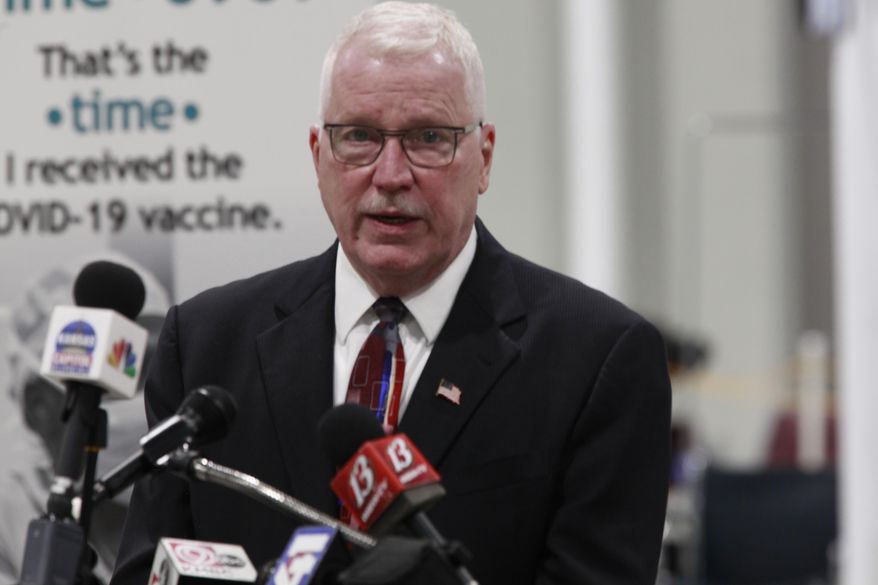 Dr. Lee Norman, head of the Kansas Department of Health and Environment, speaks to reporters during a news conference following a tour of a mass COVID-19 vaccination site, Monday, March 15, 2021, at the Stormont Vail Events Center in Topeka, Kan. Norman says the state could distribute five times as many doses of vaccines as the state has been receiving from the federal government. (AP Photo/John Hanna)