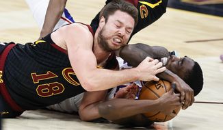 Cleveland Cavaliers&#39; Matt Dellavedova, left, ties up Philadelphia 76ers&#39; Shake Milton for a jump ball during the second half of an NBA basketball game Thursday, April 1, 2021, in Cleveland. (AP Photo/Ron Schwane)