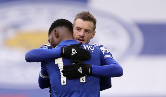 Leicester&#39;s Kelechi Iheanacho celebrates with Jamie Vardy, right, after scoring the opening goal during the English Premier League soccer match between Leicester City and Sheffield United at the King Power Stadium in Leicester, England, Sunday, March 14, 2021. (Alex Pantling/Pool via AP)