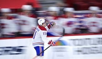 Montreal Canadiens&#39; Brendan Gallagher (11) celebrates a goal against the Ottawa Senators as he skates past the bench during the third period of an NHL hockey game Thursday, April 1, 2021, in Ottawa, Ontario. (Sean Kilpatrick/The Canadian Press via AP)