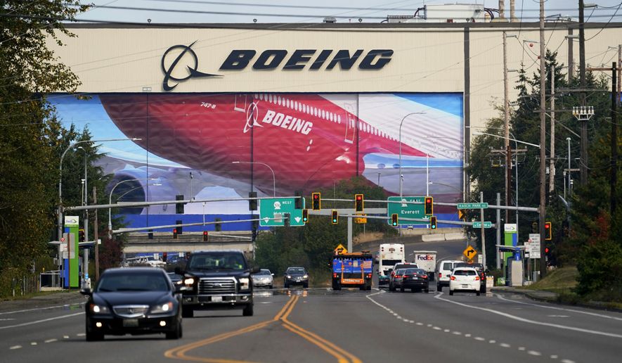 FILE - In this Oct. 1, 2020 file photo, traffic passes the Boeing airplane production plant, in Everett, Wash.  U.S. manufacturers expanded in March 2021 at the fastest pace in 37 years, a sign of strengthening demand as the pandemic wanes and government emergency aid flows through the economy.  (AP Photo/Elaine Thompson, file)