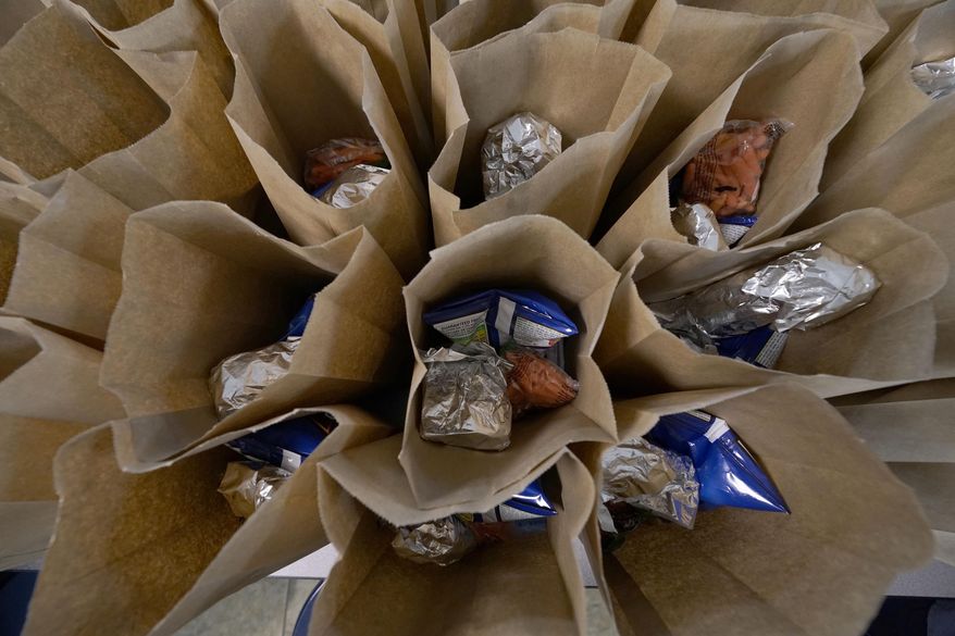 Bagged lunches await stapling before being distributed to students at the county&#x27;s Tri-Plex Campus involving the students from the Jefferson County Elementary School, the Jefferson County Upper Elementary School and the Jefferson County Junior High School on Wednesday, March 3, 2021 in Fayette, Miss. As one of the most food insecure counties in the United States, many families and their children come to depend on the free meals as a means of daily sustenance. (AP Photo/Rogelio V. Solis)