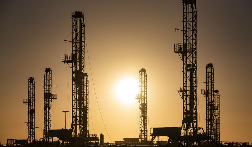The morning sun rises behind oil rigs sitting in storage Saturday, Feb. 6, 2021 at a yard outside of Odessa, Texas. The OPEC oil cartel and allied countries said Thursday, April 1, 2021 that they have decided to add gradually add back some 2 million barrels per barrel per day of oil production from May to July, moving cautiously in pace with the recovery of the global economy from the COVID-19 pandemic. (Eli Hartman/Odessa American via AP, file)