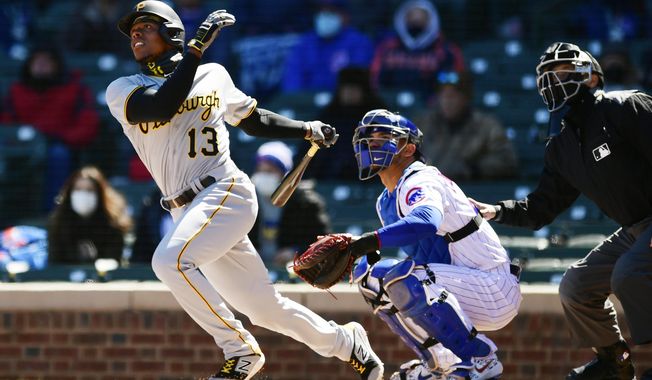 Pittsburgh Pirates&#x27; Ke&#x27;Bryan Hayes (13) watches his two-run home run during the first inning of a baseball game against the Chicago Cubs Thursday, April 1, 2021, on opening day at Wrigley Field in Chicago. (AP Photo/Paul Beaty)