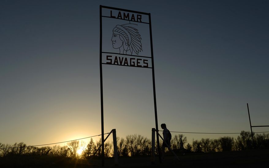 FILE — Alina Balasoiu, a student at Lamar High School, walks back to school after playing in a soccer game in the fields behind the school in this file photograph taken March 31, 2015. Colorado lawmakers are considering a proposal to ban Native American mascots in public schools and colleges. the state Senate Education Committee is scheduled to discuss a measure Thursday, April 1, 2021 that would impose a $25,000 monthly fine on public schools, colleges and universities that continue to use an American Indian-themed mascot after June 1, 2022. (RJ Sangosti/The Denver Post via The AP)