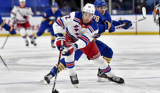 New York Rangers center Filip Chytil (72) reaches for the puck in front of Buffalo Sabres defenseman Jacob Bryson (78) during the first period of an NHL hockey game in Buffalo, N.Y., Thursday, April 1, 2021. (AP Photo/Adrian Kraus)