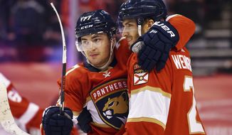Florida Panthers center Alex Wennberg (21) celebrates an overtime goal against the Detroit Red Wings with teammate center Frank Vatrano (77) during an NHL hockey game Thursday, April 1, 2021, in Sunrise, Fla. (AP Photo/Jim Rassol)
