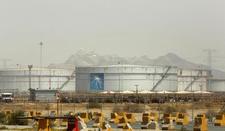 Storage tanks are seen at the North Jiddah bulk plant, an Aramco oil facility, in Jiddah, Saudi Arabia, Sunday, March 21, 2021. Saudi Arabia’s state-backed oil giant Aramco announced Sunday that its profits nearly halved in 2020 to $49 billion, a big drop that came as the coronavirus pandemic roiled global energy markets. (AP Photo/Amr Nabil)
