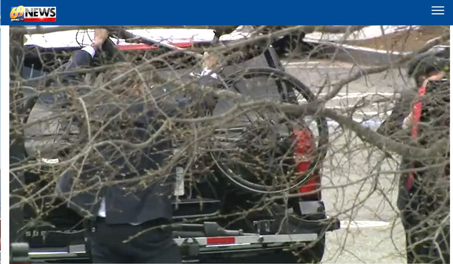 A member of U.S Secretary of Transportation Pete Buttigieg&#39;s security detail takes a bike off an SUV, April 1, 2021. Mr. Buttigieg then used the bike to travel a short distance to a Cabinet meeting. (Image: WFMZ-TV 69 video screenshot)