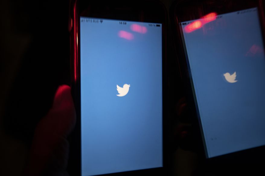 In this Wednesday, March 10, 2021 file photo, a mobile phone user turns on the Twitter application on his smartphone in Moscow, Russia. (AP Photo/Alexander Zemlianichenko, File)