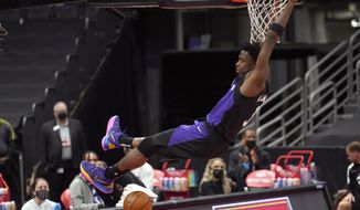 Toronto Raptors forward OG Anunoby (3) follows through on a slam dunk against the Golden State Warriors during the first half of an NBA basketball game Friday, April 2, 2021, in Tampa, Fla. (AP Photo/Chris O&#39;Meara)