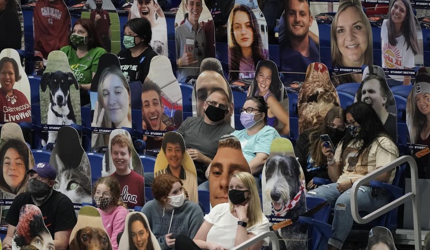 Fans sit among cardboard cutouts before the start of a women's Final Four NCAA college basketball tournament semifinal game between Stanford and South Carolina Friday, April 2, 2021, at the Alamodome in San Antonio. (AP Photo/Morry Gash)
