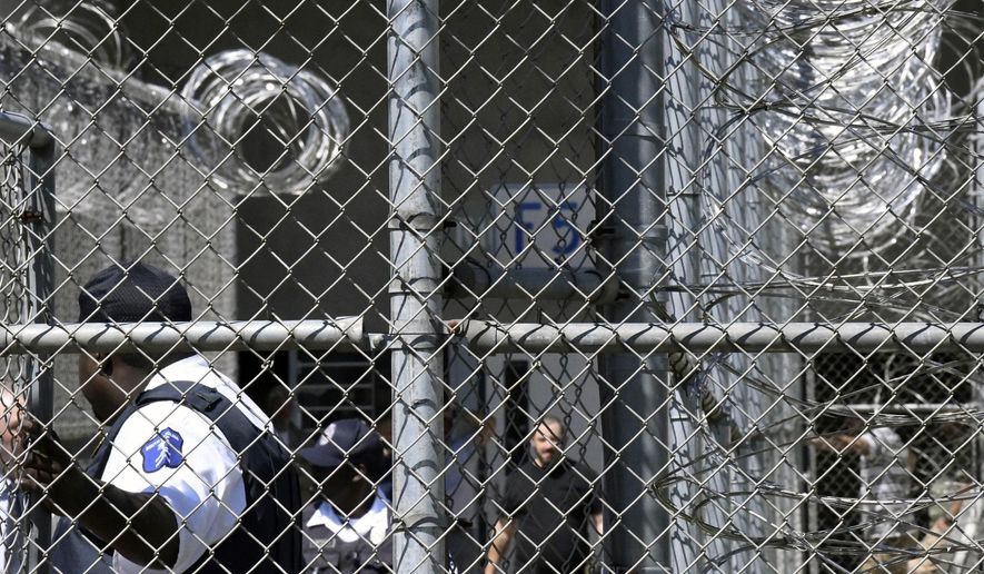 FILE - In this Wednesday, April 10, 2019 file photo, Prison staff work at Lee Correctional Institution in Bishopville, S.C. A slew of new lawsuits accuse South Carolina prisons officials of negligence and constitutional rights violations in a 2018 riot in which seven inmates were killed and more than a dozen others injured. (AP Photo/Meg Kinnard, File)