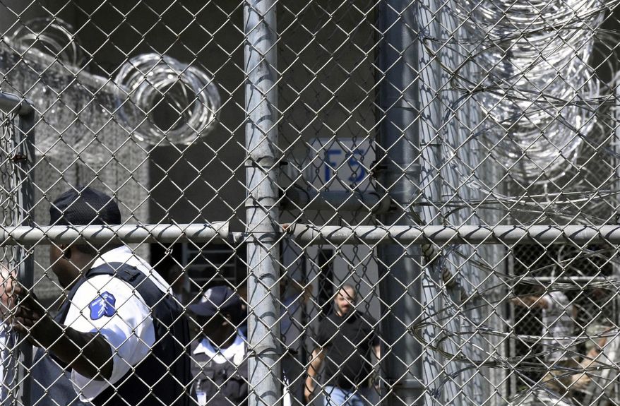 FILE - In this Wednesday, April 10, 2019 file photo, Prison staff work at Lee Correctional Institution in Bishopville, S.C. A slew of new lawsuits accuse South Carolina prisons officials of negligence and constitutional rights violations in a 2018 riot in which seven inmates were killed and more than a dozen others injured. (AP Photo/Meg Kinnard, File)