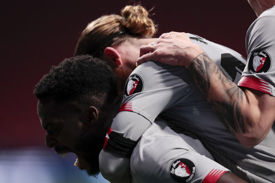 Athletic Bilbao's Iker Muniain, right, celebrates after scoring his side's first goal with his teammate Inaki Williams, left, during the Spanish La Liga soccer match between Atletico Madrid and Athletic Bilbao at Wanda Metropolitano stadium in Madrid, Spain, Wednesday, March 10, 2021. (AP Photo/Bernat Armangue)