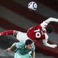 Arsenal&#39;s Nicolas Pepe, right, falls over Liverpool&#39;s Andrew Robertson during the English Premier League soccer match between Arsenal and Liverpool at the Emirates Stadium in London, England, Saturday, April 3, 2021. (Catherine Ivill/Pool via AP)