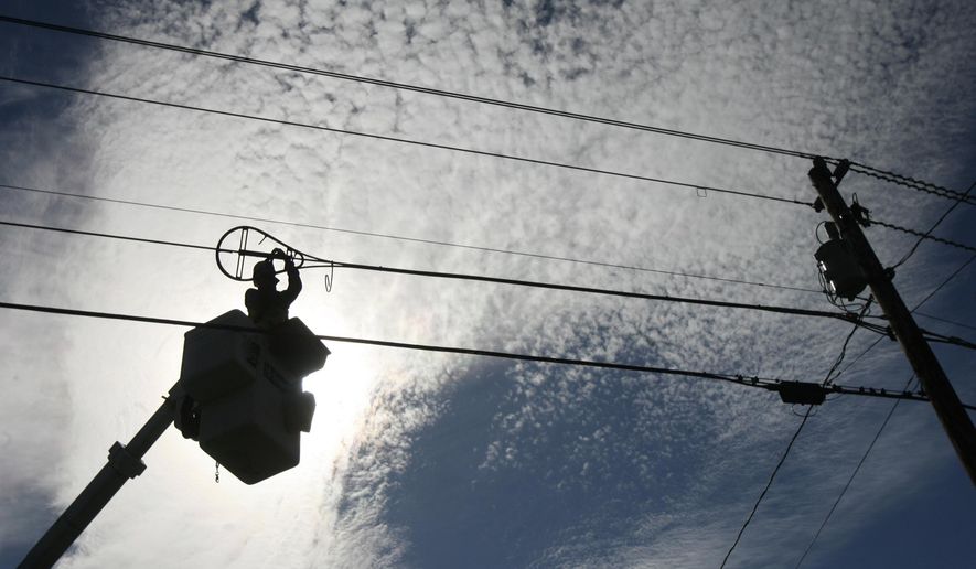 FILE - In this Oct. 2, 2007 file photo, A.J. Bowen of Schupp's Line Construction, Inc. works on fiber-optic installation in Norton, Vt. Even though the federal government has spent tens of billions of dollars to close the digital divide, tens of millions of Americans still aren’t online. The Biden administration has now broached a big number, $100 billion, in an effort to get all Americans connected. (AP Photo/Toby Talbot, File)