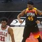 Utah Jazz guard Donovan Mitchell (45) flexes his muscles as Chicago Bulls forward Thaddeus Young (21) walks away in the second half during an NBA basketball game Friday, April 2, 2021, in Salt Lake City. (AP Photo/Rick Bowmer)