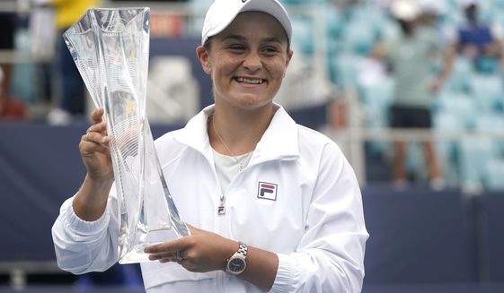 Ashleigh Barty of Australia poses with the trophy after winning her match against Bianca Andreescu of Canada during the finals at the Miami Open tennis tournament, Saturday, April 3, 2021, in Miami Gardens, Fla. Barty won 6-3, 4-0, as Andreescu retired due to injury. (AP Photo/Lynne Sladky)