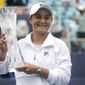 Ashleigh Barty of Australia poses with the trophy after winning her match against Bianca Andreescu of Canada during the finals at the Miami Open tennis tournament, Saturday, April 3, 2021, in Miami Gardens, Fla. Barty won 6-3, 4-0, as Andreescu retired due to injury. (AP Photo/Lynne Sladky)