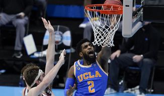 UCLA forward Cody Riley drives to the basket ahead of Gonzaga forward Drew Timme, left, during the second half of a men&#39;s Final Four NCAA college basketball tournament semifinal game, Saturday, April 3, 2021, at Lucas Oil Stadium in Indianapolis. (AP Photo/Darron Cummings)