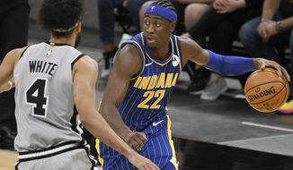 Indiana Pacers&#39; Caris LeVert (22) drives against San Antonio Spurs&#39; Derrick White during the second half of an NBA basketball game Saturday, April 3, 2021, in San Antonio. (AP Photo/Darren Abate)